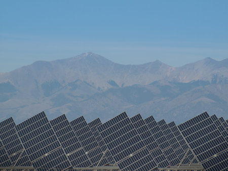 A series of large solar panels forms a symmetrical line at a power plant in the San Luis Valley of...