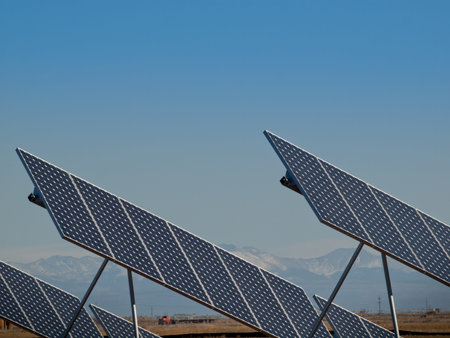A series of large solar panels forms a symmetrical line at a power plant in the San Luis Valley of central Colorado. These panels utilize a tracking system to follow the sun, collecting its energy and using photovoltaic cells to transform the sunlight intのeditorial素材