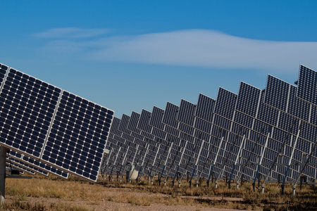 A series of large solar panels forms a symmetrical line at a power plant in the San Luis Valley of...