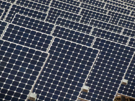 A series of large solar panels forms a symmetrical line at a power plant in the San Luis Valley of central Colorado. These panels utilize a tracking system to follow the sun, collecting its energy and using photovoltaic cells to transform the sunlight intのeditorial素材