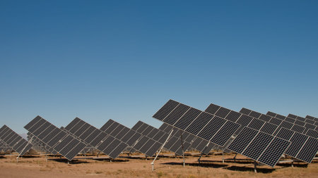 A series of large solar panels forms a symmetrical line at a power plant in the San Luis Valley of...