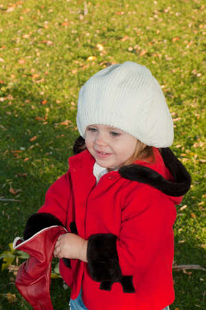 Girl toddler in autumn park.の写真素材
