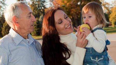 Father sharing a moment of happiness with his daughter and grandaughter.の写真素材