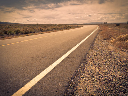 Rural paved road with yellow line.