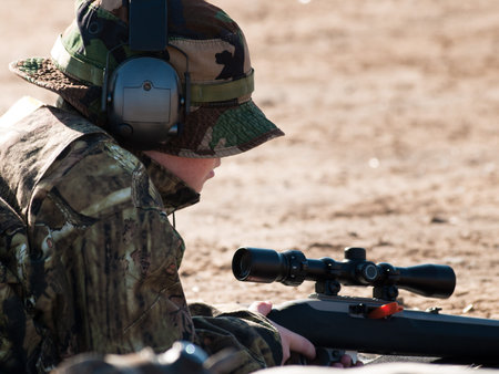 Young boy practicing rifle marksmanship at the Appleseed Project.