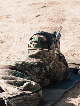 Young boy practicing rifle marksmanship at the Appleseed Project.