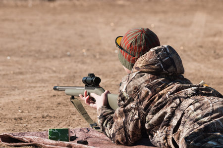 Young boy practicing rifle marksmanship at the Appleseed Project.