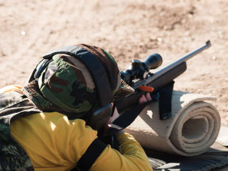 Young boy practicing rifle marksmanship at the Appleseed Project.の写真素材