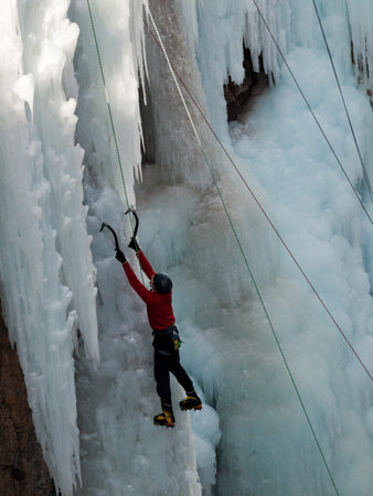 Alpinist ascenting a frozen waterfall in Ice park, Ouray.のeditorial素材