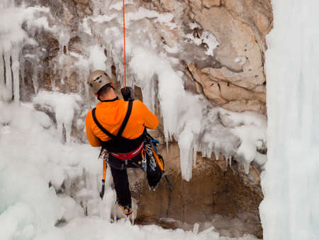 Alpinist ascenting a frozen waterfall in Ice park, Ouray.のeditorial素材