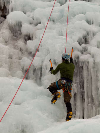 Alpinist ascenting a frozen waterfall in Ice park, Ouray.のeditorial素材