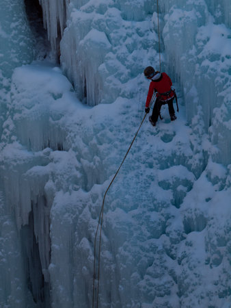 Alpinist ascenting a frozen waterfall in Ice park, Ouray.のeditorial素材