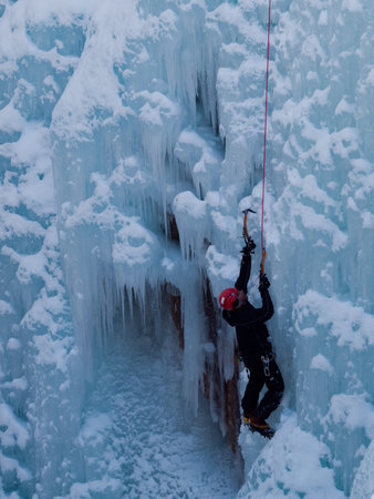 Alpinist ascenting a frozen waterfall in Ice park, Ouray.のeditorial素材