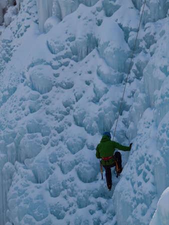 Alpinist ascenting a frozen waterfall in Ice park, Ouray.のeditorial素材