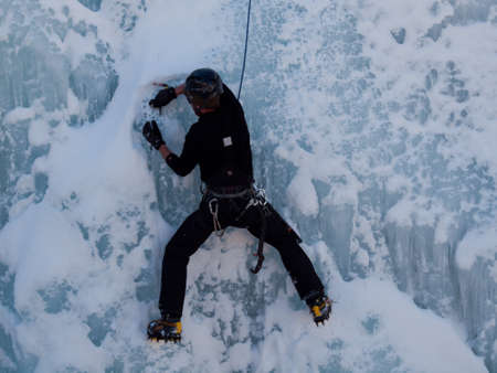 Alpinist ascenting a frozen waterfall in Ice park, Ouray.のeditorial素材