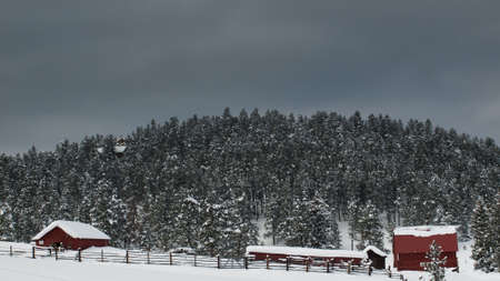Old red barn after snow storm in Evergreen, Colorado.のeditorial素材
