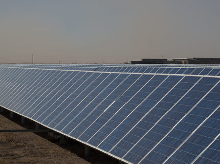 A series of large solar panels forms a symmetrical line at a power plant in the San Luis Valley of...