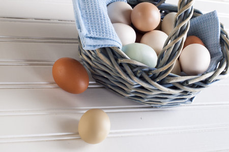 Fresh multi-color farm eggs on the table.
