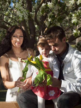 Young family with toddler girl in Spring park.の写真素材