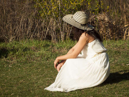 Young woman in white dress with open hands.の写真素材