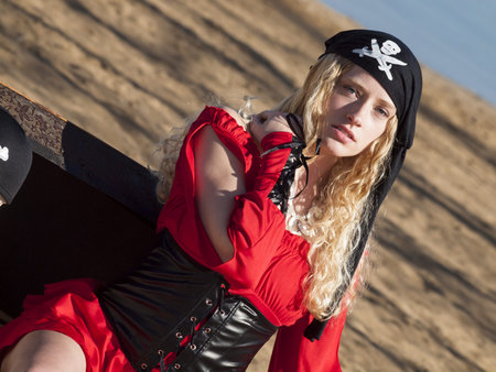 Beautiful young female pirate in red dress.の写真素材