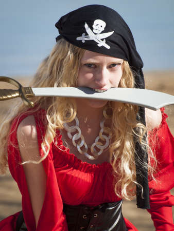 Beautiful young female pirate in red dress.の写真素材