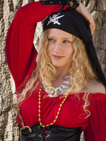Beautiful young female pirate in red dress.の写真素材