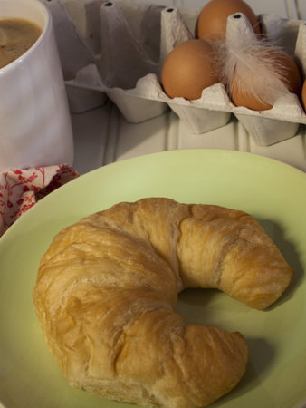 Fresh croissant served with chai tee latte for breakfast.の写真素材