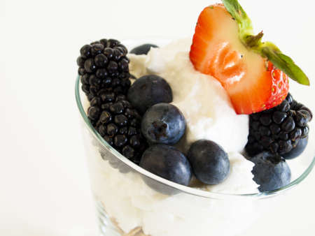 Yogurt parfait with blueberries, blackberries, strawberries, and Granola.の写真素材