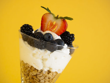 Yogurt parfait with blueberries, blackberries, strawberries, and Granola.の写真素材