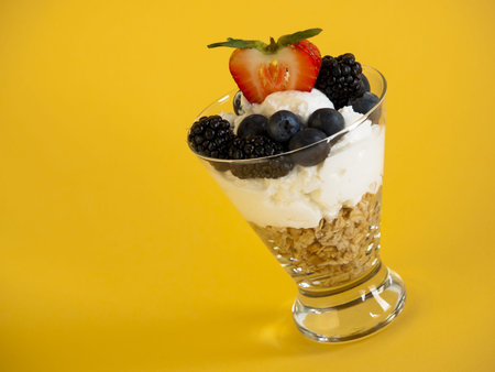 Yogurt parfait with blueberries, blackberries, strawberries, and Granola.の写真素材