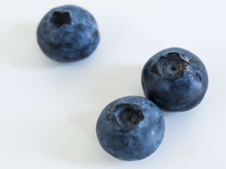 Fresh bluberries from local market on white background. Blueberries contain anthocyanins,  and various phytochemicals, which possibly have a role in reducing risks of some diseases.の写真素材