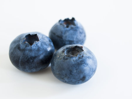 Fresh bluberries from local market on white background. Blueberries contain anthocyanins,  and various phytochemicals, which possibly have a role in reducing risks of some diseases.の写真素材