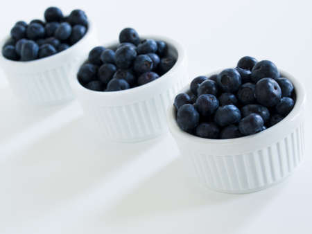 Fresh bluberries from local market on white background. Blueberries contain anthocyanins,  and various phytochemicals, which possibly have a role in reducing risks of some diseases.の写真素材