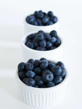 Fresh bluberries from local market on white background. Blueberries contain anthocyanins,  and various phytochemicals, which possibly have a role in reducing risks of some diseases.の写真素材