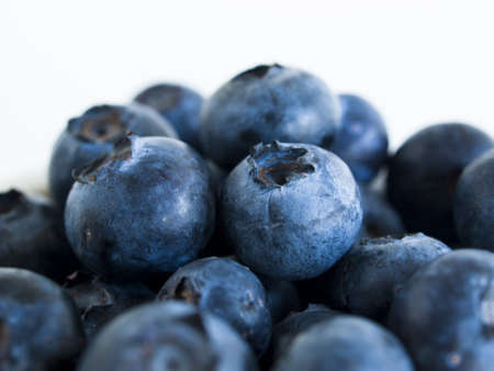 Fresh bluberries from local market on white background. Blueberries contain anthocyanins,  and various phytochemicals, which possibly have a role in reducing risks of some diseases.の写真素材