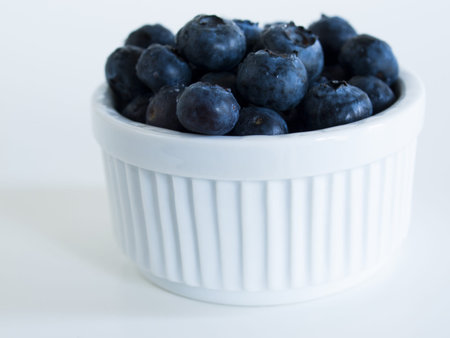 Fresh bluberries from local market on white background. Blueberries contain anthocyanins,  and various phytochemicals, which possibly have a role in reducing risks of some diseases.の写真素材