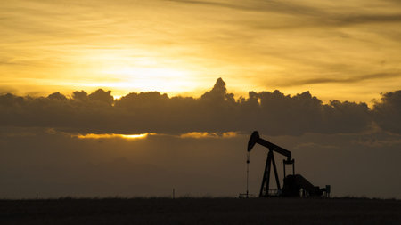 A pumpjack silhoutte with dramatic sunset.の写真素材