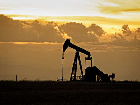 A pumpjack silhoutte with dramatic sunset.の写真素材