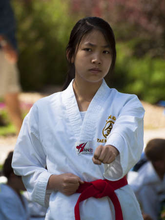 2012 J. W. Kim Tae Kwon Do school belt test in the park.のeditorial素材