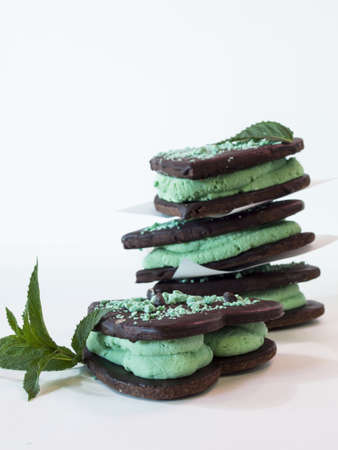 Chocolate cookies with mint filling on white background.の写真素材