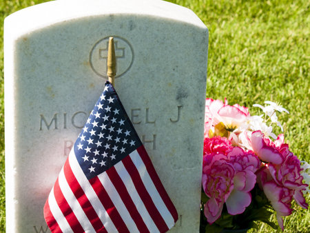 Endless row of white marble gravestones continues above hilltop at the Fort Logan National Cemetery...