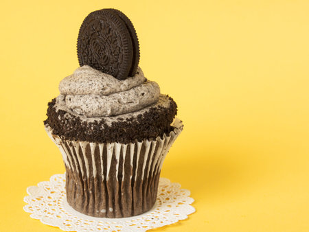 Gourmet Oreo cupcake on yellow backround.
