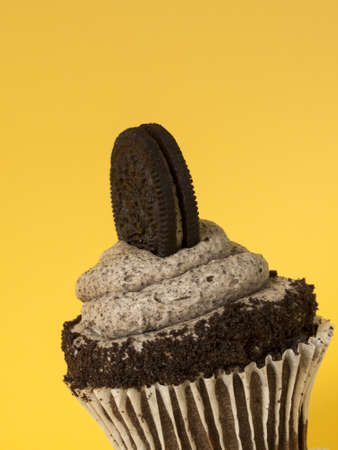 Gourmet Oreo cupcake on yellow backround.の写真素材