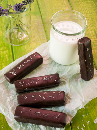 Gourmet lavender chocolate bars on white parchment paper.の写真素材
