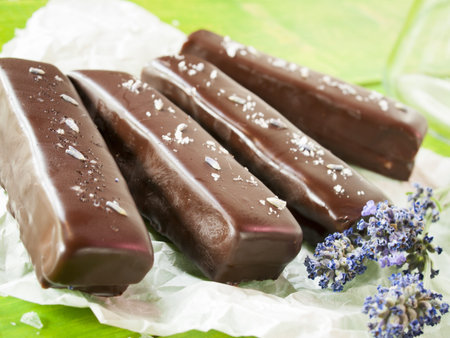 Gourmet lavender chocolate bars on white parchment paper.の写真素材