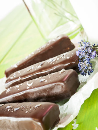 Gourmet lavender chocolate bars on white parchment paper.の写真素材