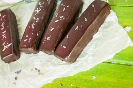 Gourmet lavender chocolate bars on white parchment paper.の写真素材