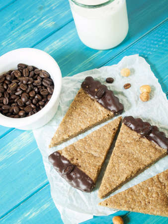 Gourmet hazelnut and coffee chocolate bars on white parchment paper.の写真素材