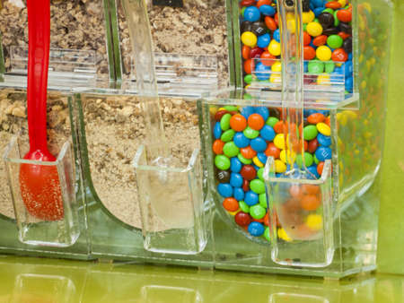 Frozen yogurt toppings bar. Yogurt toppings ranging from fresh fruits, nuts, fresh-cut candies, syrups and sprinkles.の写真素材